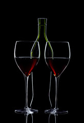 Pair of glasses of red wine with bottle