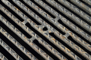 Cast iron cover of a drainage well, by the wayside.