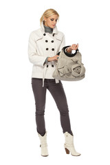 Fototapeta premium beautiful young woman looking for something in her bag