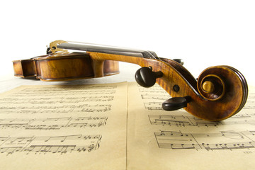 Vintage viola with head close-up and sheet music