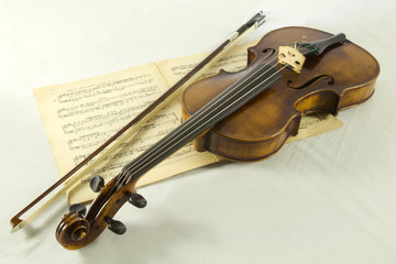 Vintage viola with bow and sheet music