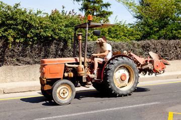 Man is driving his tractor