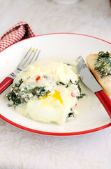 Baked eggs with spinach and focaccia