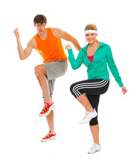 Obraz na płótnie Canvas Healthy girl and guy in sportswear doing aerobics