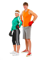 Portrait of fit young woman and man in boxing gloves