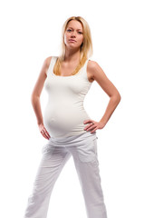 Beautiful young pregnant woman posing over white background