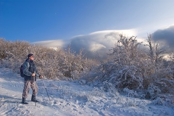 hiker in a winter mountains