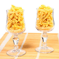 Macaroni in a glass on a straw mat