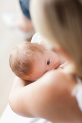 Above view of baby getting breastfed