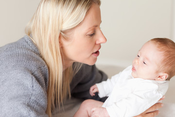Side view of mother laying down her newborn