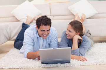 Smiling couple surfing on the internet