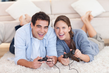 Delighted couple playing video games