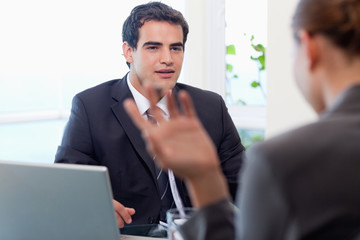 Handsome manager interviewing a female applicant