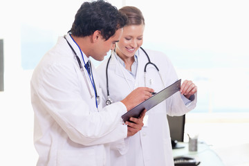 Assistant doctors reading off clip board