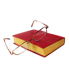 glasses and a red book isolated on white background