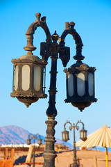 Fototapeta na wymiar old rusty street lamps on the beach