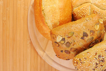 Bread and rolls on a cherry wood table