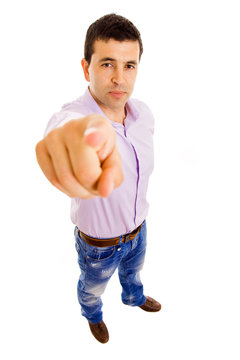 Young man full body pointing to the camera over white background
