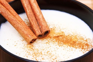 Two sticks of cinnamon on semolina with milk