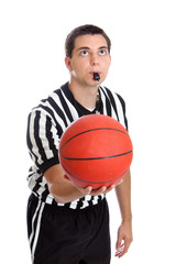Teen basketball referee about to throw ball