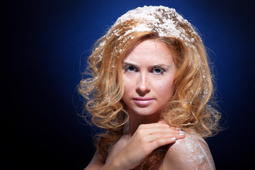 Young beautiful woman with snowy skin