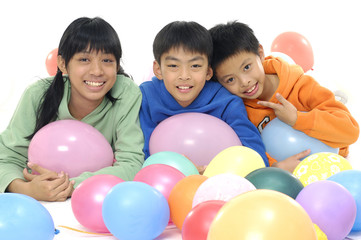 Fototapeta na wymiar Group Of Young Children In Studio With Balloons