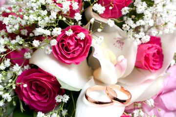 Gold wedding rings on flower