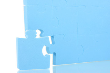 Blue puzzles closeup, isolated on white