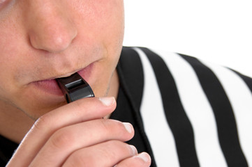Mouth of teen referee blowing a whistle