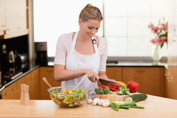 Obraz na płótnie Canvas Woman slicing vegetables