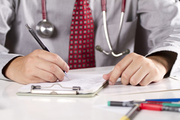 working doctor, a doctor busy working in his office.