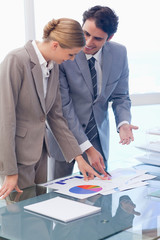 Portrait of smiling business people looking at statistics