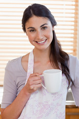 Portrait of a woman holding a cup of coffee