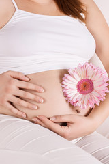 Fototapeta na wymiar pregnant woman touching her tummy