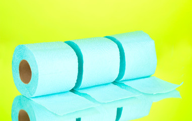 blue rolls of toilet paper on green background