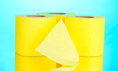 yellow rolls of toilet paper on blue background
