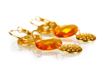 Earrings with yellow stone isolated on the white