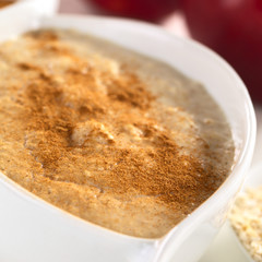 Porridge made of oatmeal and milk with cinnamon