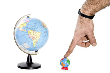 two globes and a hand