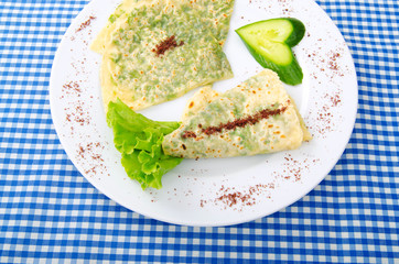 Herb stuffed pancaces in the plate