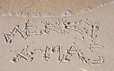 Merry X-mas sign on the sand