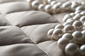 Obraz premium String of pearls on a gray fabric