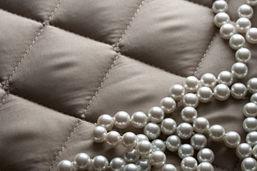 String of pearls on a gray fabric