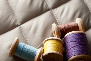 Thread bobbins on a gray fabric