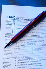 Obraz premium Tax form and a red pen