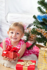 little girl at a Christmas fir-tree