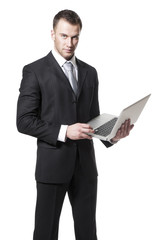 Handsome young businessman in black suit holding notebook