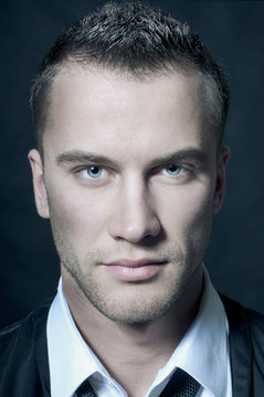 Close-up portrait of young handsome man with green eyes