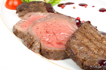 Grilled meat sliced on a plate