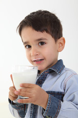 Child drinking glass of milk